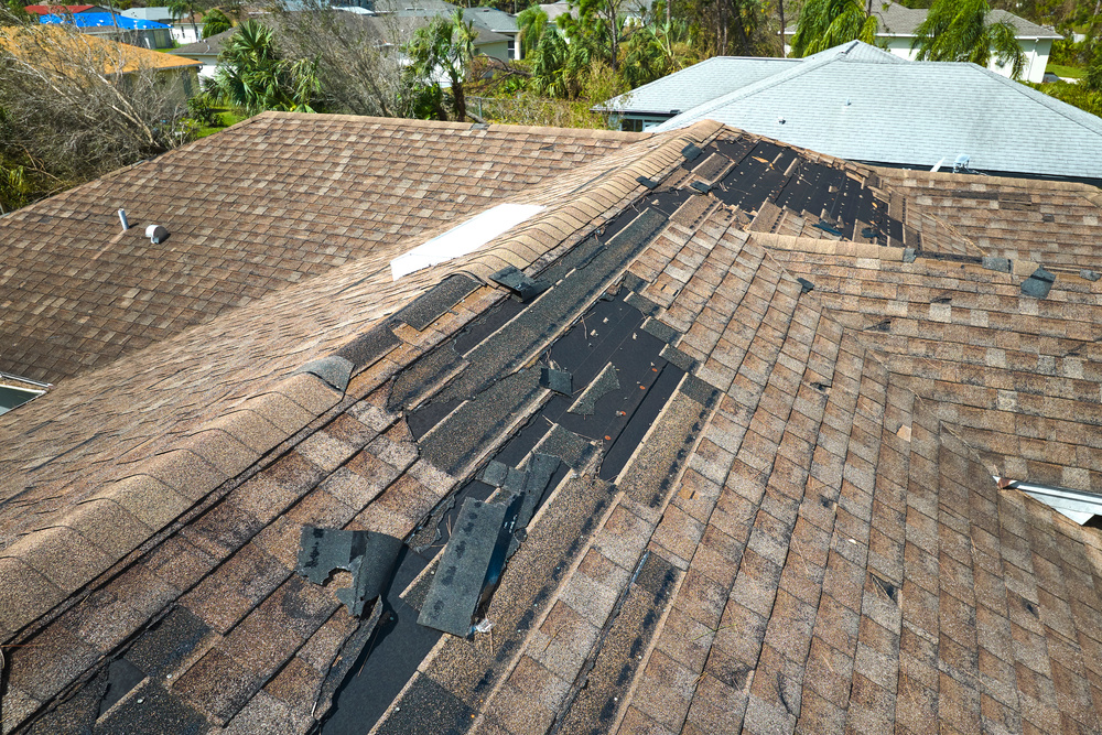 Damaged House Roof With Missing Shingles After Hurricane Ian In Florida Consequences Of Natural Disaster